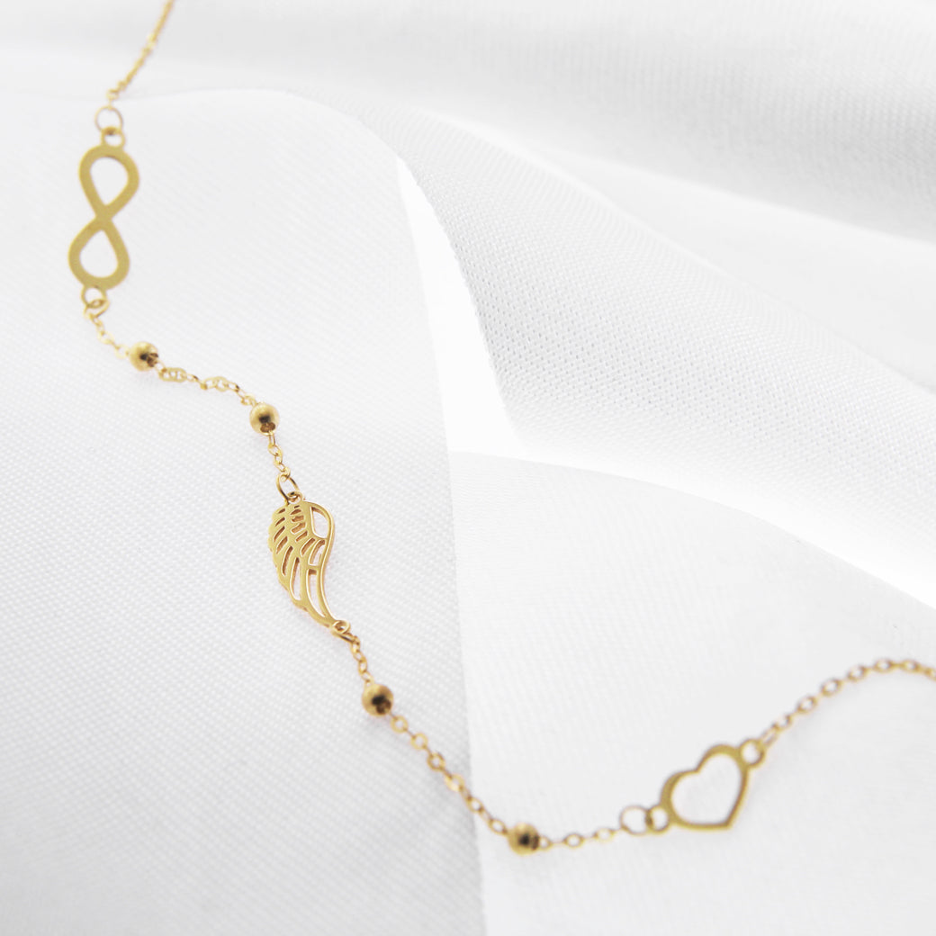 Złota bransoletka z sercem, skrzydłem i nieskończonością